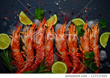 Langoustines, Australian, freshly frozen on ice, top view, lime and greens, 117515892