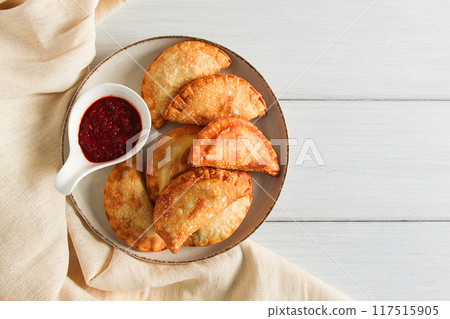 Fried chebureks, close-up, on a light background, no people, Fried chebureks, close-up, on a light background, no people, 117515905