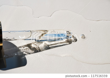 Pipette with serum on a beige background. 117516339