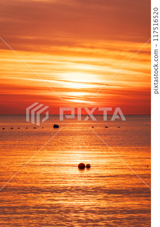Beautiful red and orange sunrise over the sea. Beautiful red and orange sunrise over the sea. 117516520