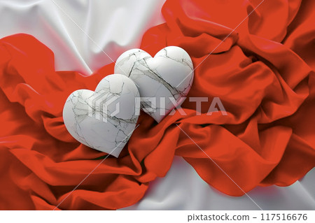 Overhead view of cracked alabaster hearts on red and white lycra fabric, symbolizing love and empathy for special occasions 117516676
