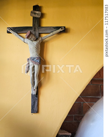 Old crucifix on a yellow wall indoor, Modra, Slovakia Old crucifix on a yellow wall indoor, Modra, Slovakia 117517083