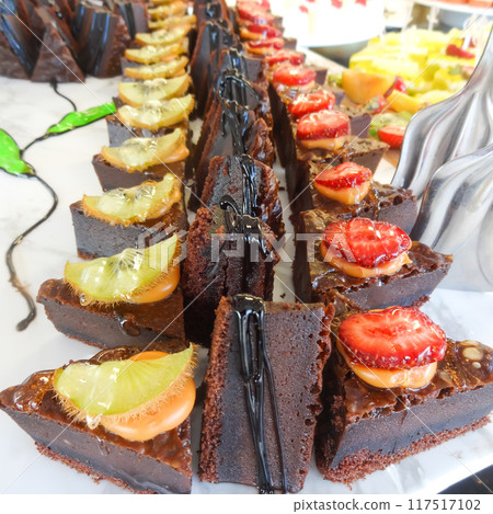 Assorted Pastries Topped with Fresh Fruit Slices Assorted Pastries Topped with Fresh Fruit Slices 117517102