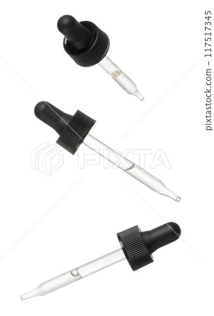 Glass pipette with black tip and white liquid inside on isolated background 117517345