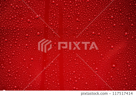 Closeup rain drops on red car with hydrophobic coating Closeup rain drops on red car with hydrophobic coating 117517414