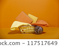 Small metal basket from hardware store on orange background 117517649