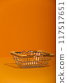 Small metal empty grocery basket on orange background 117517651