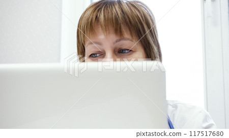 Close-Up of Female Doctor's Eyes While Working at Computer Close-Up of Female Doctor's Eyes While Working at Computer 117517680