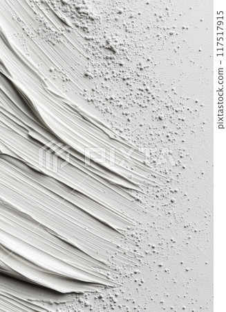 White paint smeared on a clean surface with a cap beside it 117517915