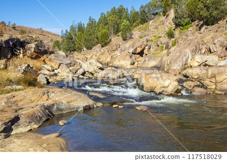 A tranquil stream flowing through the countryside in the Snowy Mountains A tranquil stream flowing through the countryside in the Snowy Mountains 117518029