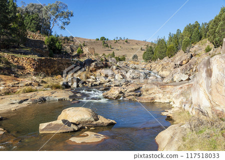 A tranquil stream flowing through the countryside in the Snowy Mountains A tranquil stream flowing through the countryside in the Snowy Mountains 117518033