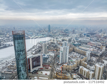 Yekaterinburg aerial panoramic view in Winter at sunset. Yekaterinburg city and pond in winter. Yekaterinburg aerial panoramic view in Winter at sunset. Yekaterinburg city and pond in winter. 117518492