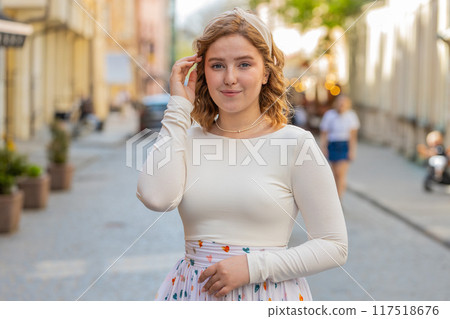 Happy redhead woman smiling looking away dreaming resting good news feel satisfied in city street 117518676