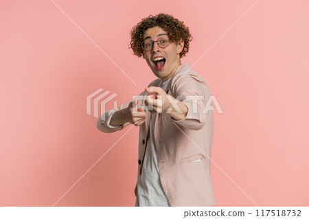 Mime Caucasian curly haired man pulling an imaginary unreal invisible rope, puts lot of effort into 117518732