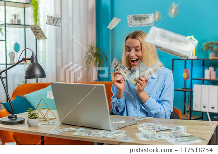 Money cash dollar rain falling on woman using laptop celebrating success play casino online game Money cash dollar rain falling on woman using laptop celebrating success play casino online game 117518734
