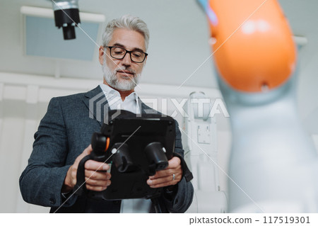 Automation, robotics engineer working on robotic knee replacement surgery project. Concept of modern technology in medicine, automated processes, healthcare. 117519301