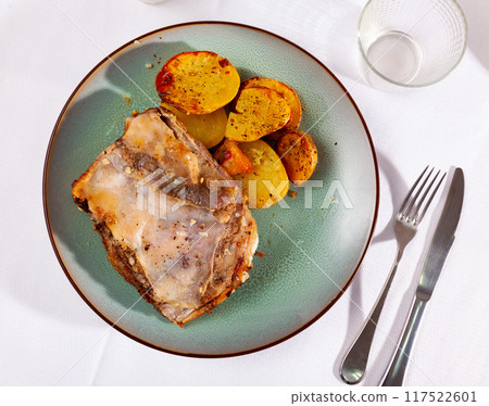Portion of roasted pork ribs with pieces of fried potatoes Portion of roasted pork ribs with pieces of fried potatoes 117522601