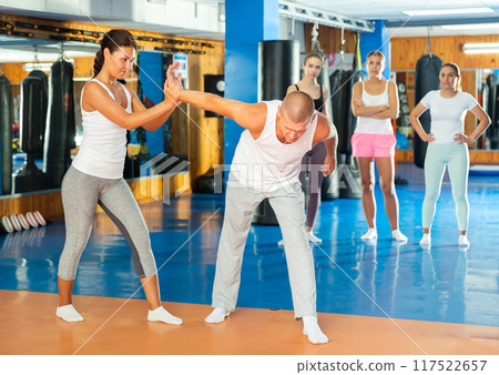 Woman doing wristlock Woman doing wristlock 117522657