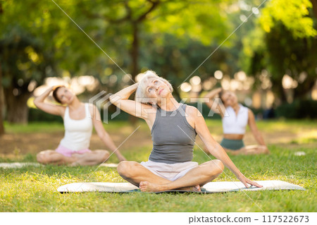 Elderly woman doing yoga in lotus position 117522673