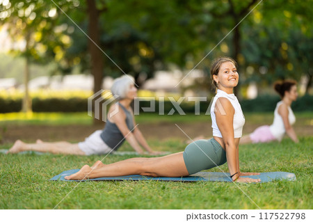 Young woman doing yoga in cobra pose Young woman doing yoga in cobra pose 117522798