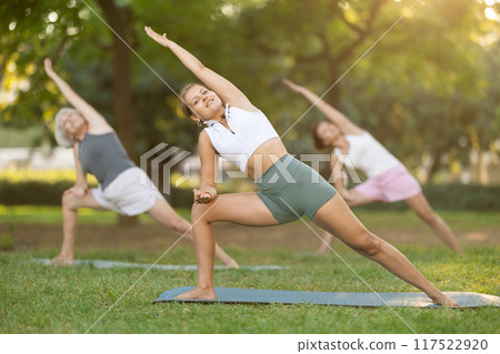 Young woman doing yoga in park 117522920