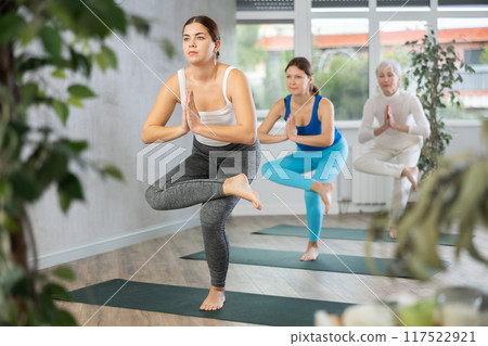Young woman doing yoga in fitness studio Young woman doing yoga in fitness studio 117522921