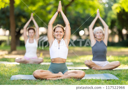 Young woman doing yoga in lotus pose Young woman doing yoga in lotus pose 117522966