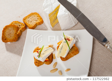 Toasted bread with soft blue cheese and orange Toasted bread with soft blue cheese and orange 117522982