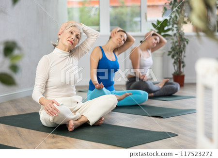 Elderly woman doing yoga in fitness studio Elderly woman doing yoga in fitness studio 117523272