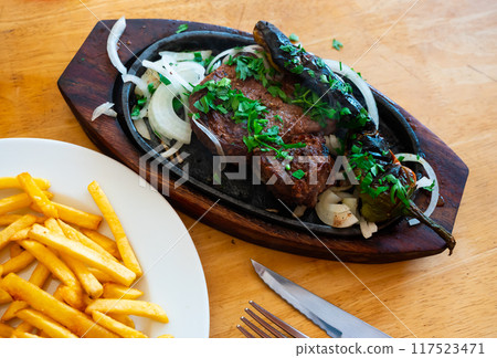 Grilled beef with spicy pepper and potatoes served beautifully on plate 117523471