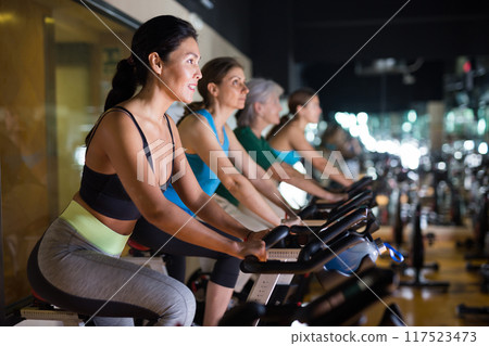 Asian woman with fitness bike in gym 117523473