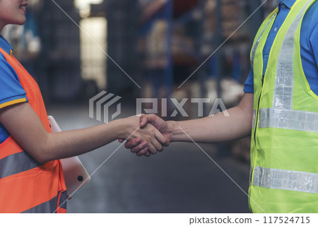 Close up warehouse worker shakehand together. Engineer man hands partnership. Diversity Coworker Men logistics Warehouse teams handshake. Multiracial Support team greeting person teamwork colleagues 117524715