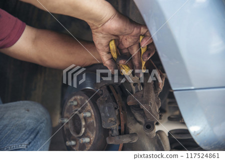 Close up Man hands fixing Car machinery vehicle mechanical service. Mechanic man hands repairing car auto repair shop. open vehicle hood checking up auto mobile. Vehicle Car maintenance engineer. Close up Man hands fixing Car machinery vehicle mechanical service. Mechanic man hands repairing car auto repair shop. open vehicle hood checking up auto mobile. Vehicle Car maintenance engineer. 117524861