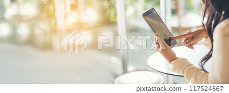 Banner Woman hands holding mobile phone outdoor surfing internet online technology lifestyle. Close up woman hand using smartphone gadget text message panoramic with copy space. Technology lifestyle 117524867