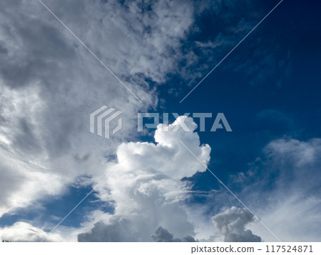 Blue sky fluffy white clouds on summer season bright clear skyline with beautiful cloudscape. Panorama blue sky clouds pattern on daylight with copy space. Cumulus cloudscape air climate sunny day 117524871
