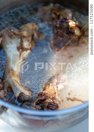 Raw meat dog food boiled in a pressure cooker - knuckles 117525090