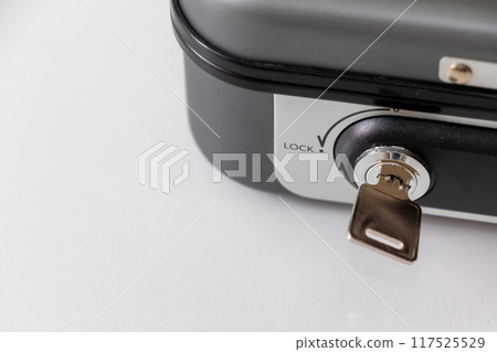 Key inserted in the key hole of the hand-held safe 117525529