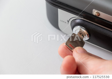 turn the key inserted in the keyhole 117525530