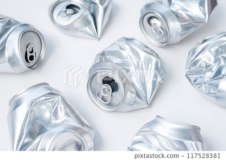 Crushed aluminum cans on white background. Recycling and waste management concepts. Crushed aluminum cans on white background. Recycling and waste management concepts. 117528381