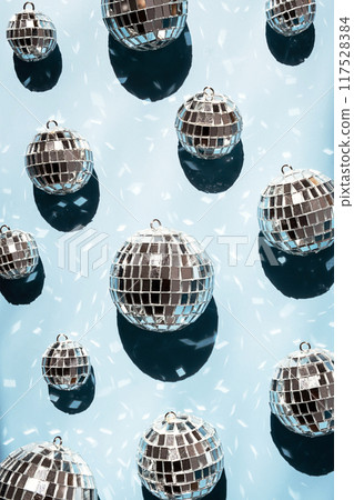 Shiny mirrored disco balls casting reflections and creating festive atmosphere. Shiny mirrored disco balls casting reflections and creating festive atmosphere. 117528384