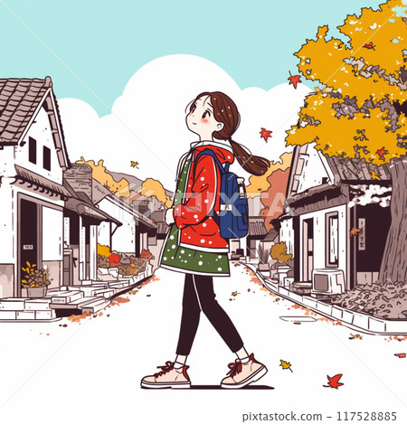 A woman walking down the autumn street 117528885