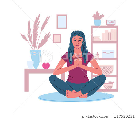 A young woman meditates in the lotus position in the room. 117529231