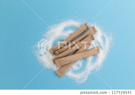 sugar packets on blue background, top view 117529541