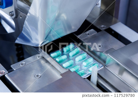 capsule pill ready on medicine aluminum foil packaging in the process of packing at automatic capsule filling machine of quality pharmaceutical factory. medical industrial and manufacturing concept capsule pill ready on medicine aluminum foil packaging in the process of packing at automatic capsule filling machine of quality pharmaceutical factory. medical industrial and manufacturing concept 117529780