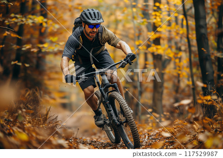 Adventurous Mountain Biker Navigates Challenging Terrain Amidst Vibrant Autumn Foliage 117529987