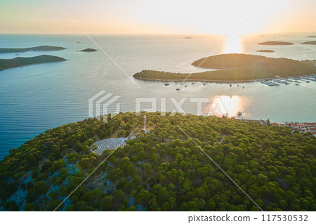Panoramic view of islands in Adriatic Sea and hedge maze among forest trees at sunset. Lavender labyrinth in Rogoznica, Croatia. Aerial view of coastal landscape. Place for summer vacation 117530532