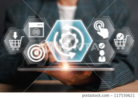 Businessman using tablet with digital marketing automation icons, representing modern online strategies and technology integration. Businessman using tablet with digital marketing automation icons, representing modern online strategies and technology integration. 117530621