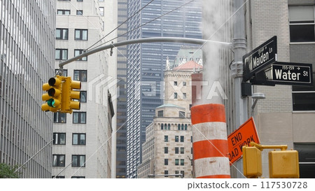 Steam vapor vented, New York City street steam system, orange vapour tube stack. Hot smoke from pipe Steam vapor vented, New York City street steam system, orange vapour tube stack. Hot smoke from pipe 117530728