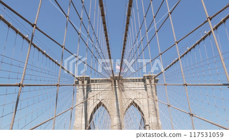 Brooklyn Bridge to Manhattan downtown, cables and blue sky. New York City iconic symbol. Travel USA. Brooklyn Bridge to Manhattan downtown, cables and blue sky. New York City iconic symbol. Travel USA. 117531059