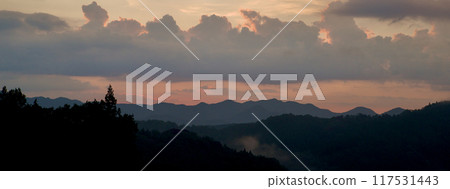 Background image banner: Clouds after rain over the mountain range and sunset, copy space Background image banner: Clouds after rain over the mountain range and sunset, copy space 117531443